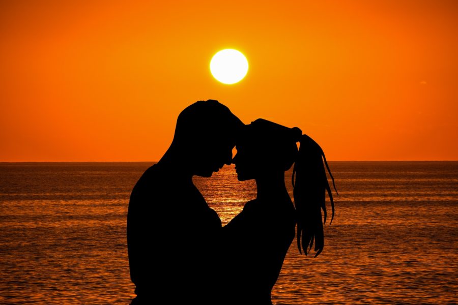 sunset couple on beach silhouette