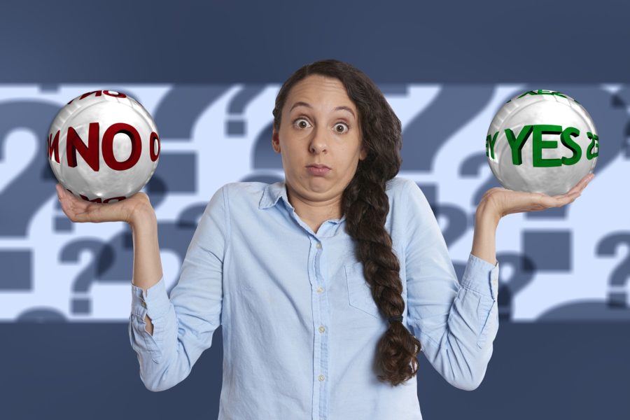 girl braided hair holding yes-no ballons